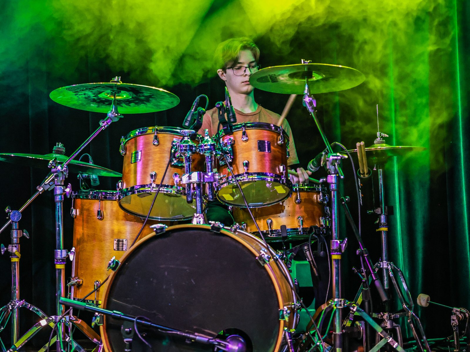 Drum Student Taking Drum Lessons From A Local Drum Teacher In Aurora/Centennial Teenage Drum Student At Rock The Stages Music School in Aurora/Centennial Performing Live On Stage