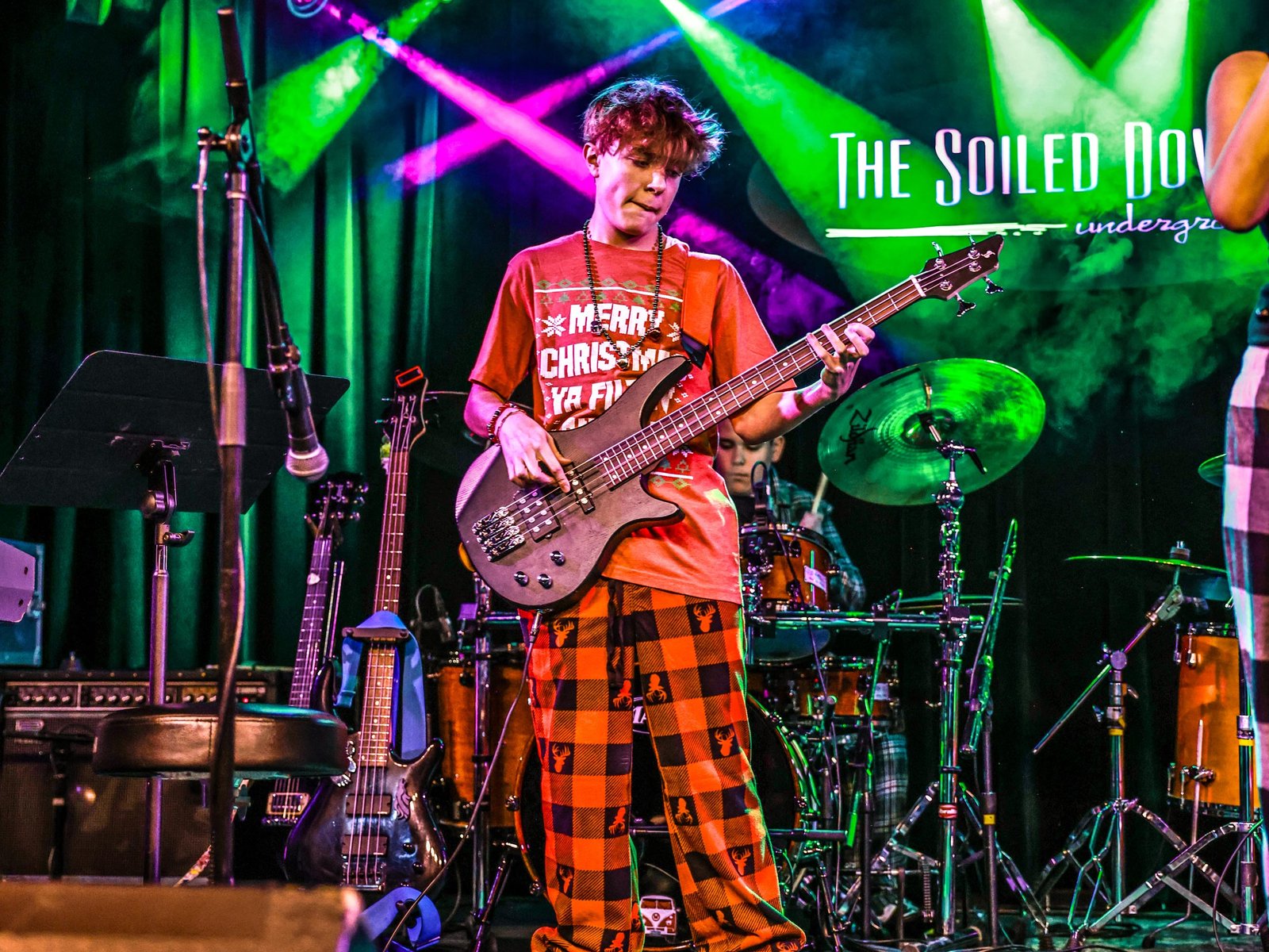 Bass Guitar Students Taking Bass Guitar Lessons From A Local Bass Guitar Teacher Teenage Bass Guitar Student At Rock The Stages Music School in Aurora/Centennial Performing Live On Stage