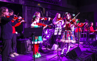 Group Of Violin/Cello Students At Rock The Stages Music School in Aurora/Centennial Performing Live On Stage Best Beginner Violin Cello