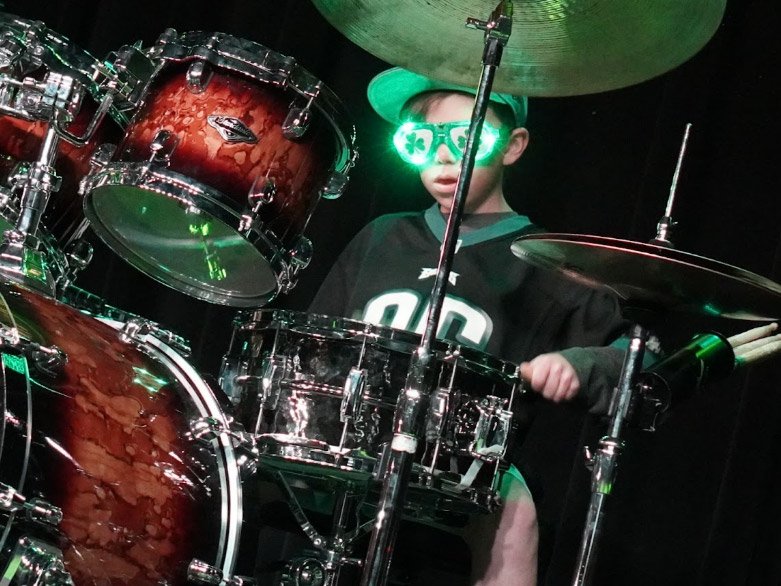 Drum Student Taking Drum Lessons From A Local Drum Teacher In Aurora/Centennial Kid Drum Student At Rock The Stages Music School in Aurora/Centennial Performing Live On Stage