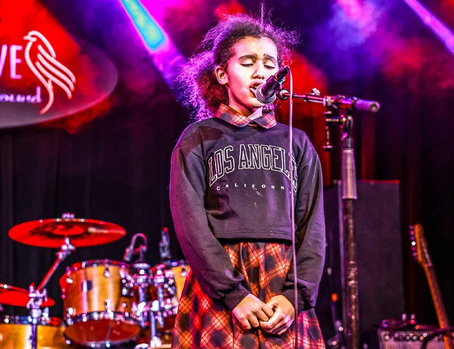 Kid Singing Student Taking Singing Lessons Kid Singing Student At Rock The Stages Music School in Aurora/Centennial